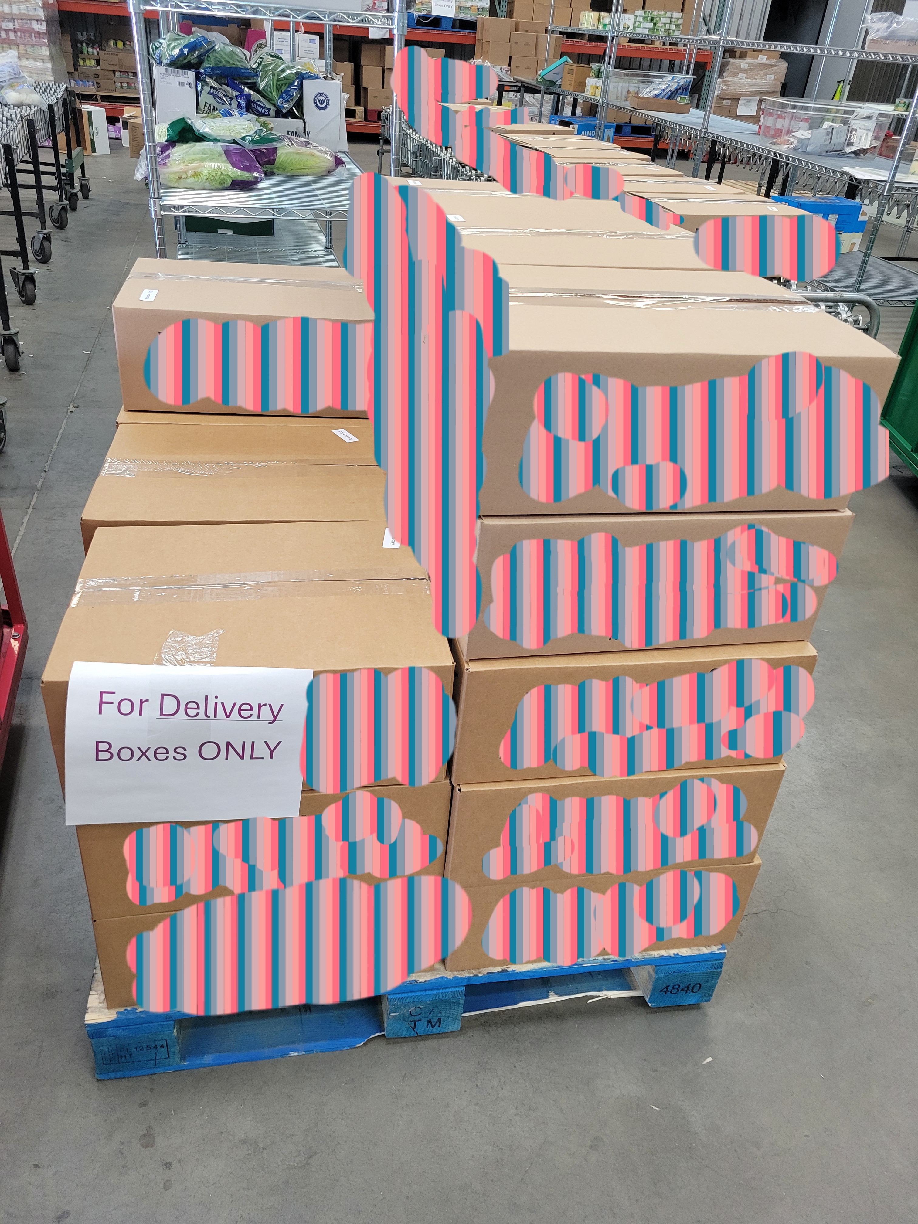 Pallet of boxes with a piece of paper that says for delivery boxes only.